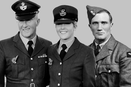A lady in an RAF uniform is looking at the camera smiling in a black and white photo.
