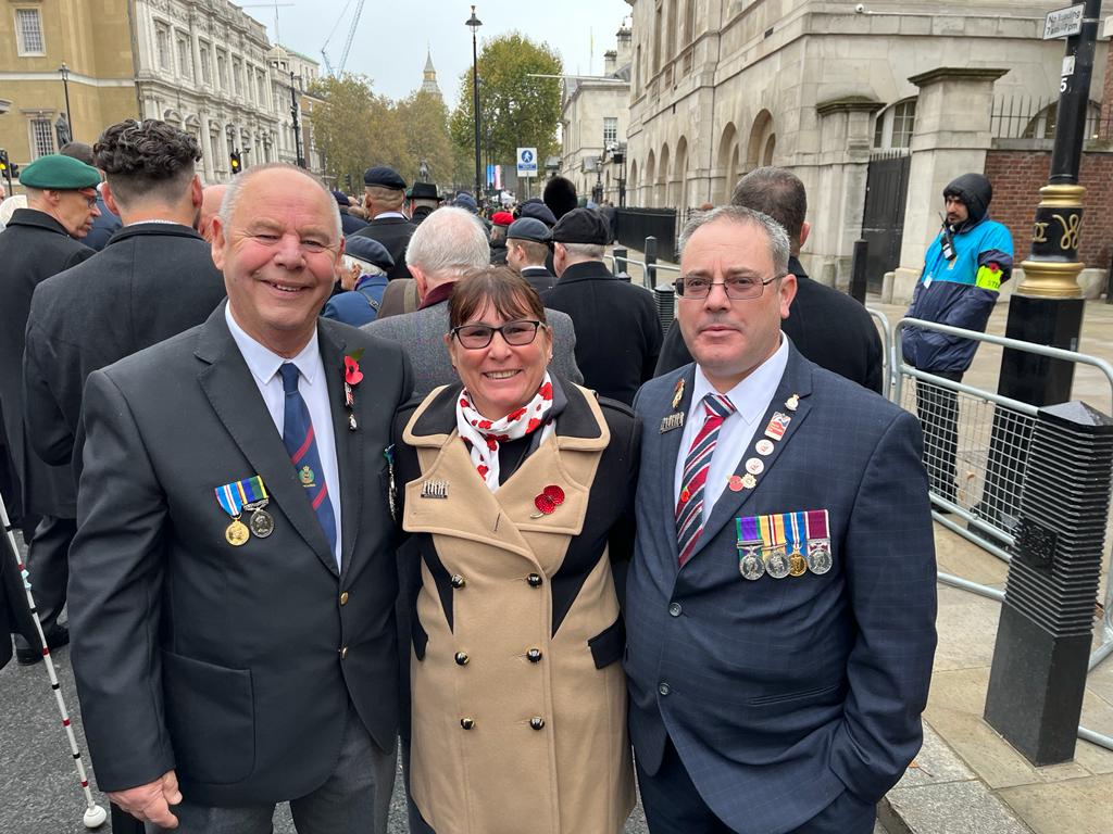 Blind veteran Andy (right) with his wife and guide and another guide waiting to start the march past the Cenotaph