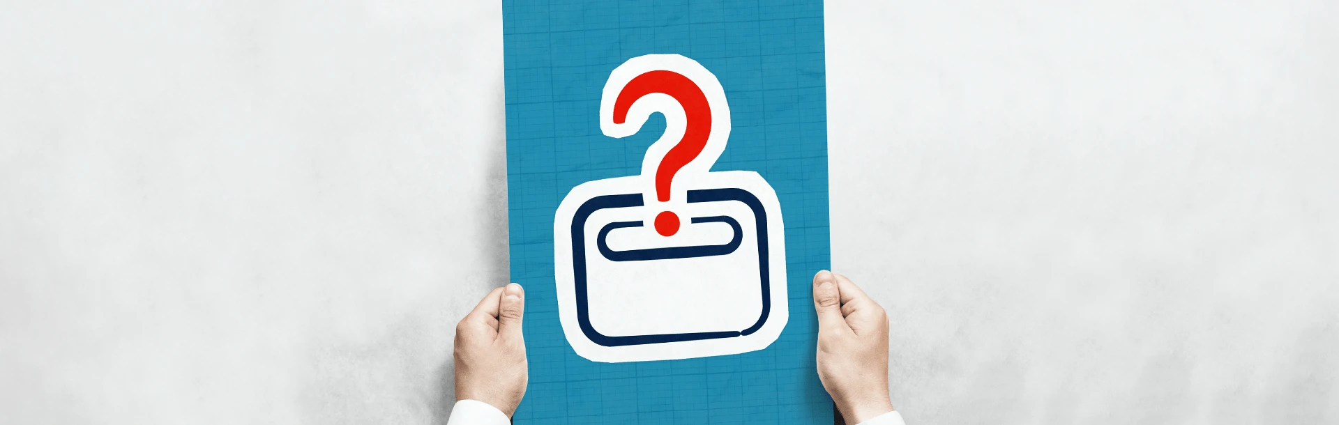 A pair of hands holding a poster with a graphic letter box and question mark