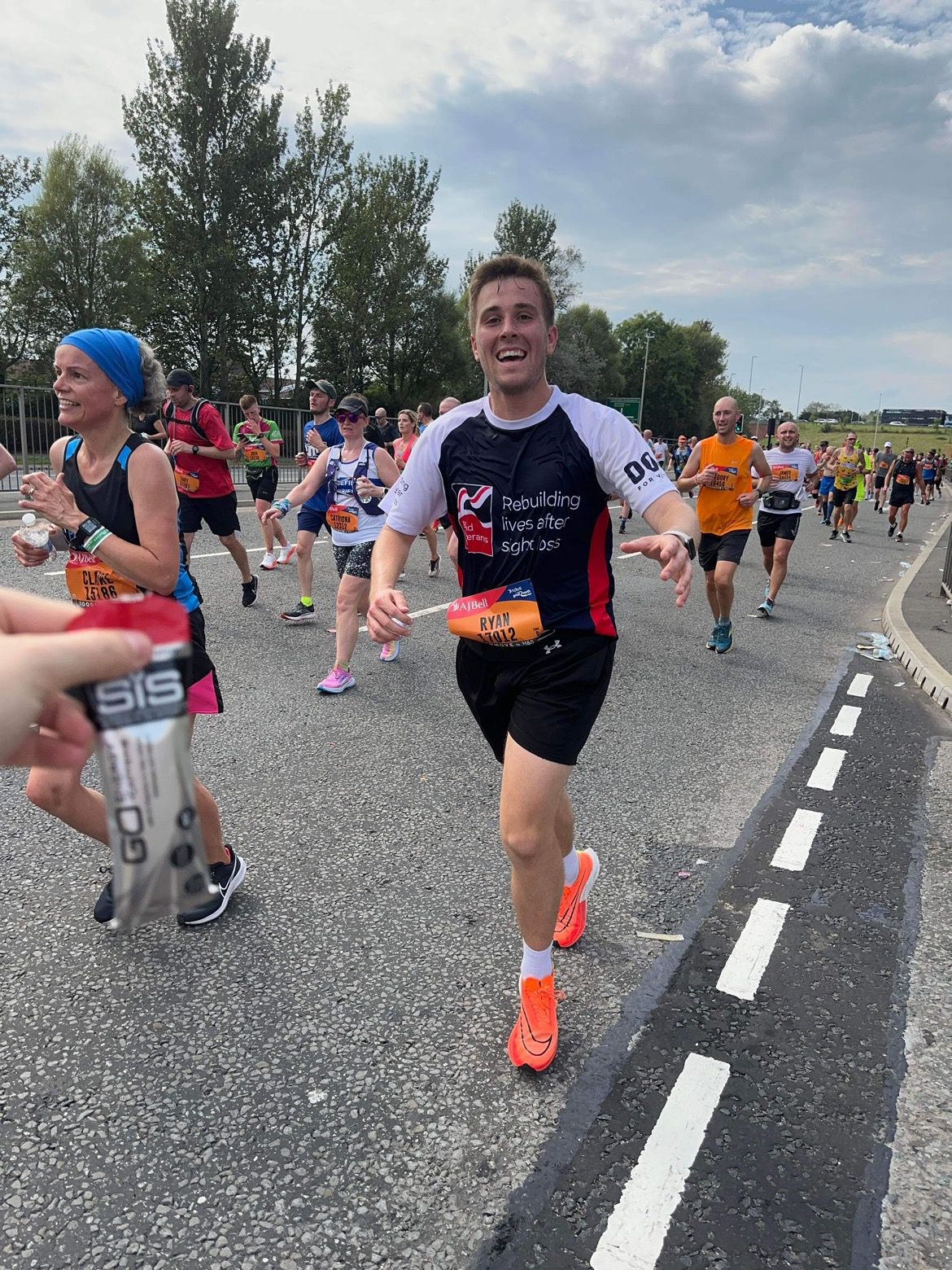 Ryan in action on the race course, smiling as he runs towards the camera.