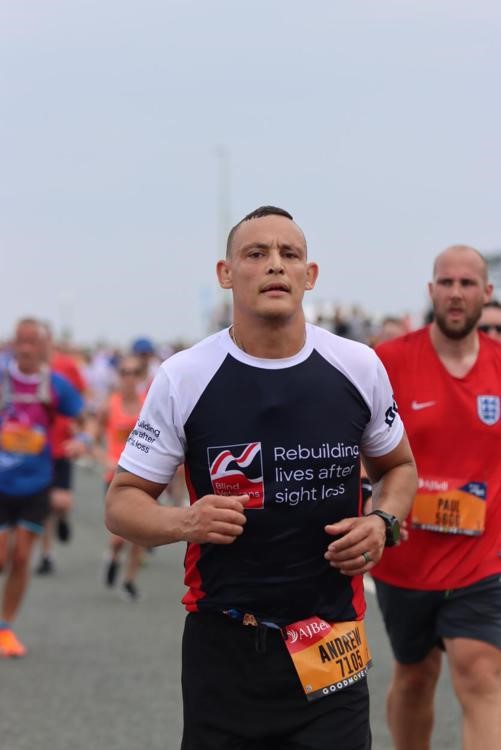 Andrew running with a crowd of others following around and behind him.