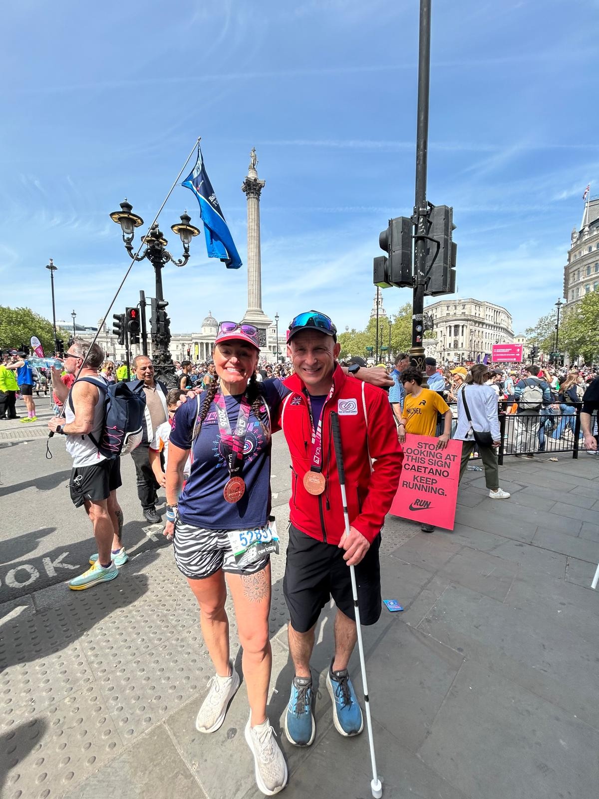 Alan and Helen stood in the sunshine with their medals around their necks