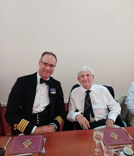 HMS Sultan Commanding Officer and D-Day veteran George are sat next to one another during the dinner