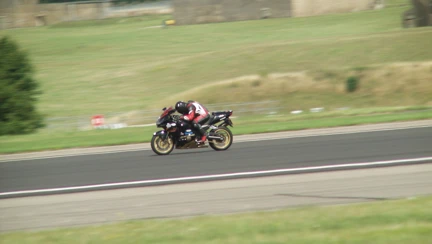 Blind veteran Billy wearing motorbike gear and riding his motorbike along a road
