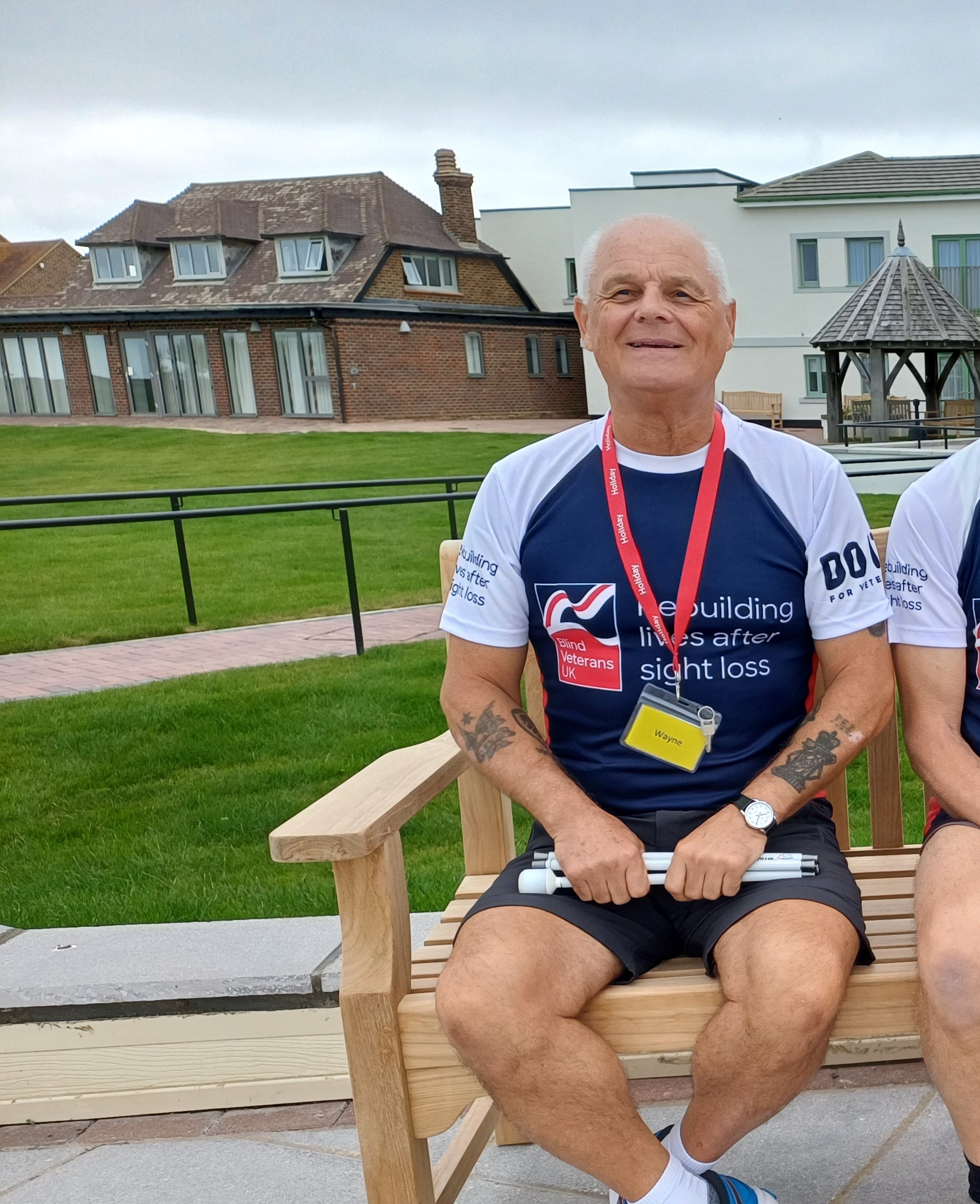 Wayne sat on a bench in the garden at Rustington