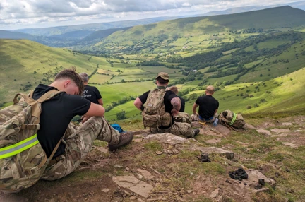 Five members of the Wrexham Army Careers Office sat down on the mountain taking in the view