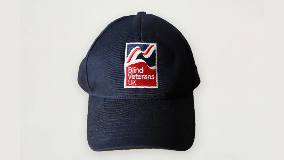 Navy blue baseball cap with Blind Veterans UK logo