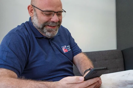 Matthew, Blind Veterans UK staff member calling on a phone