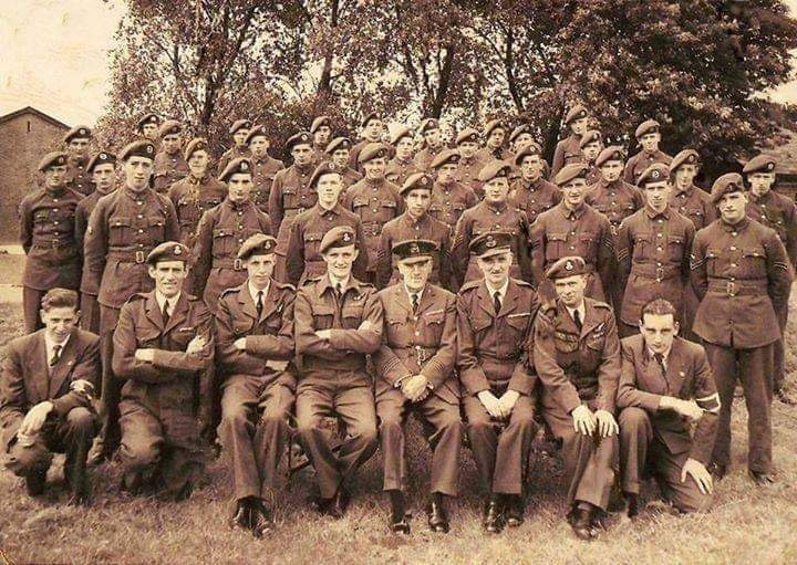 An old black and white group photograph of Ken in uniform with his squadron