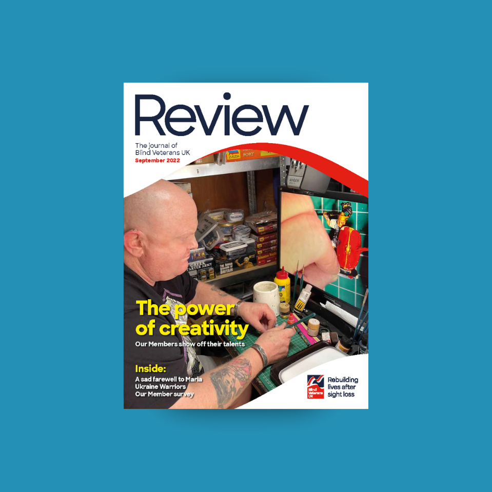 A magazine front cover with title "The power of creativity" and an image of a blind veteran using a digital magnifier to do crafts