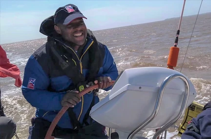 A photo of blind veteran Roan steering a speed boat