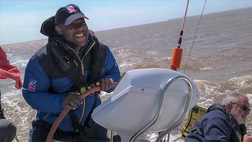 A photo of blind veteran Roan steering a speed boat