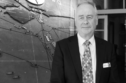 Adrian Bell CEO in front of the D-Day map at Southwick House