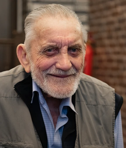 A portrait of blind veteran Ken smiling