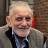A portrait of blind veteran Ken smiling