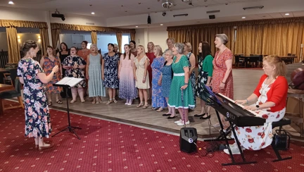 Twenty members of the Portsmouth Military Wives Choir singing to the guests