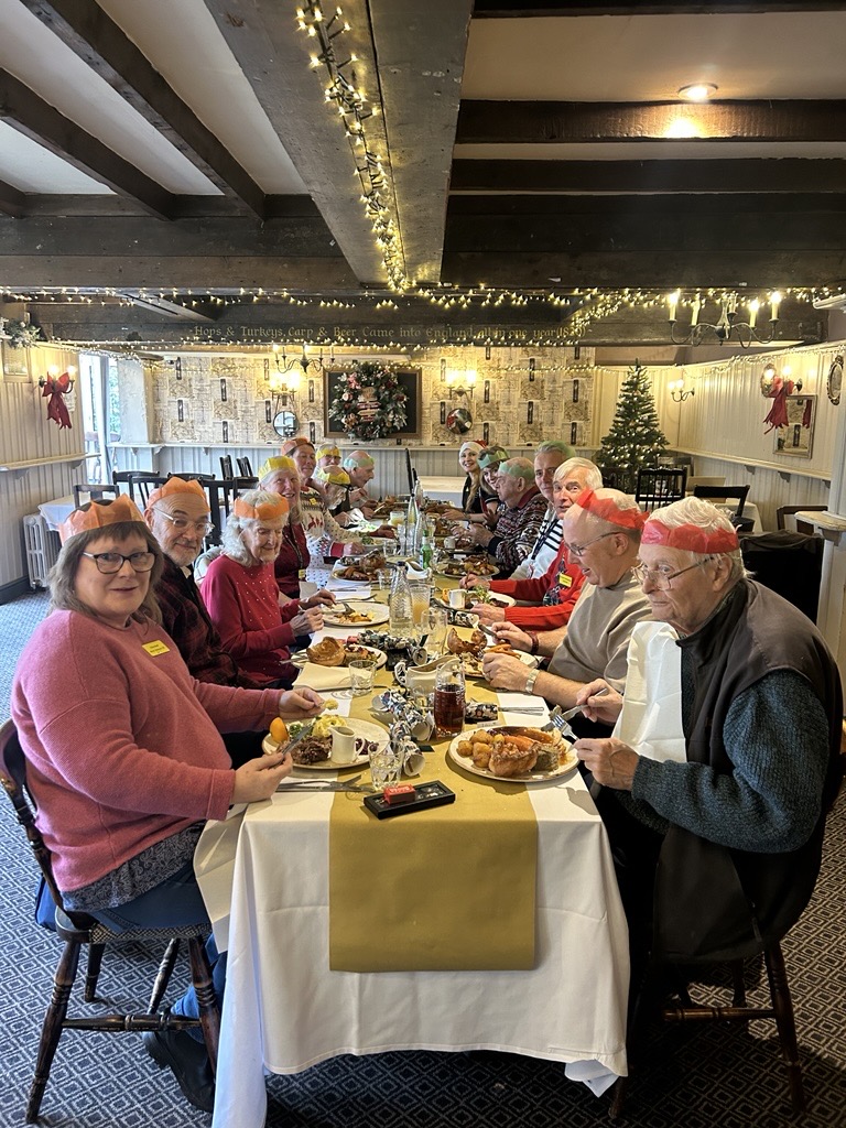 A group of veterans eat Christmas lunch together around a table