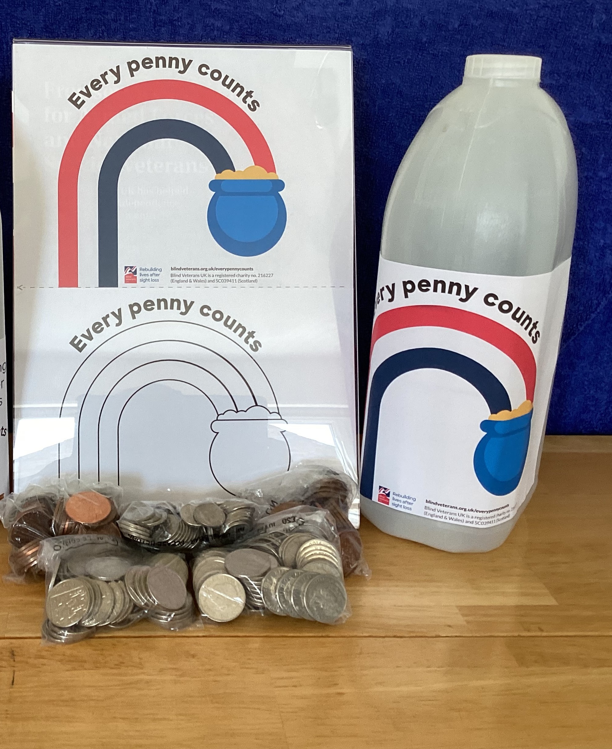 A milk carton with the Every Penny Counts pre-coloured label on it along side a print out of the colour and black and white label templates.