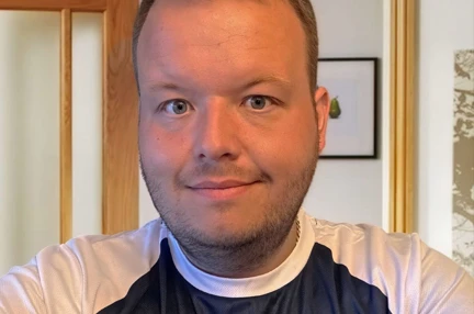 Ben wearing his Blind Veterans UK T-shirt taking a photo of himself smiling