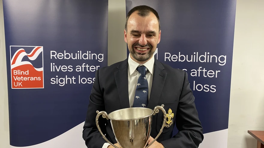 Craig Lundberg holding the Ted Higgs Trophy at the Founder's Awards 2023