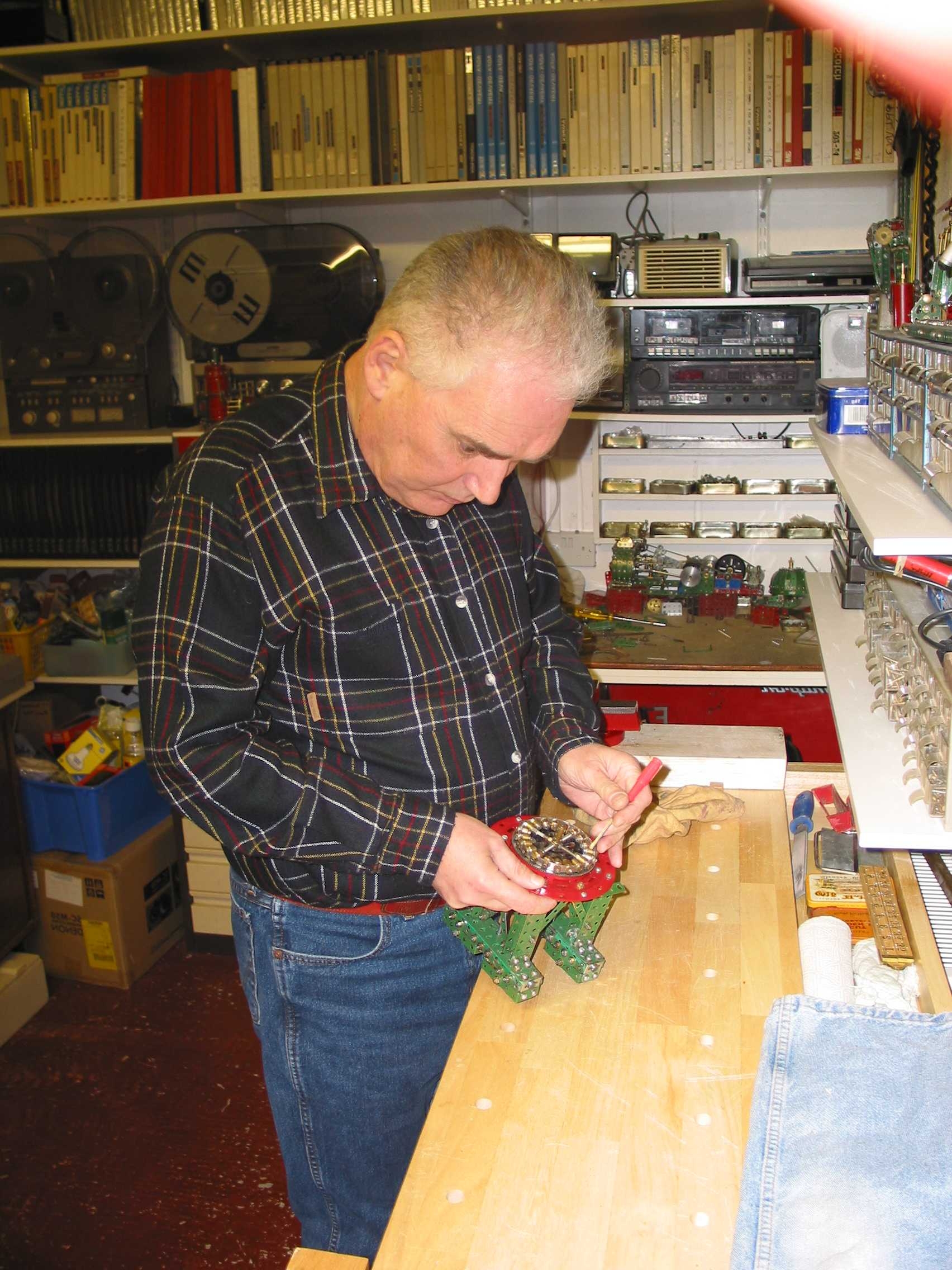 Blind veteran, Terry, pictured in his workshop, building using Meccano.