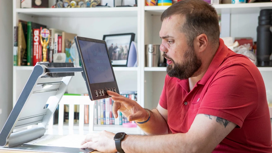 Blind veteran Simon using a scanner