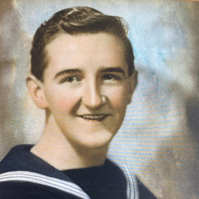 Joe as a boy wearing Navy uniform