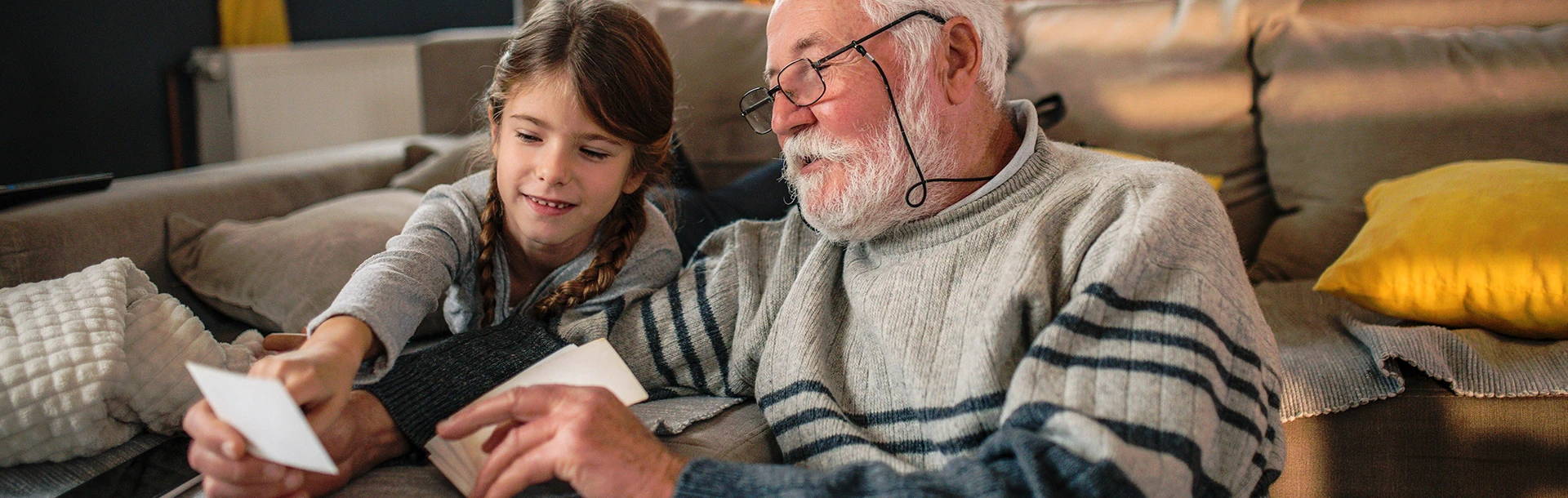 A grandad showing his granddaughter memories from past