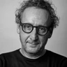 A black and white portrait of photographer Richard Cannon, wearing glasses
