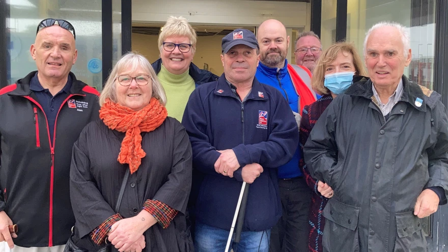 Photo of our Member design group featuring blind veterans and staff pictured outside the new wellbeing centre in Rustington