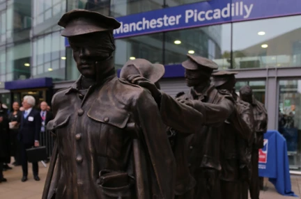 Victory Over Blindness statue depicting seven blinded soldiers leading one another with their hands on their comrades’ shoulders