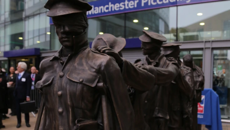 Victory Over Blindness statue depicting seven blinded soldiers leading one another with their hands on their comrades’ shoulders