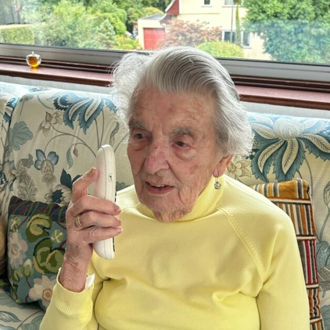 Peggy sat on the sofa with her phone