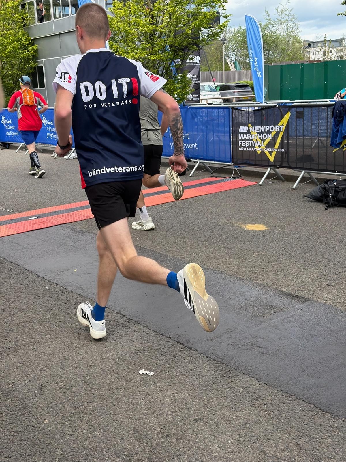 A picture of the back of Zach's Blind Veterans UK T-shirt mid-run