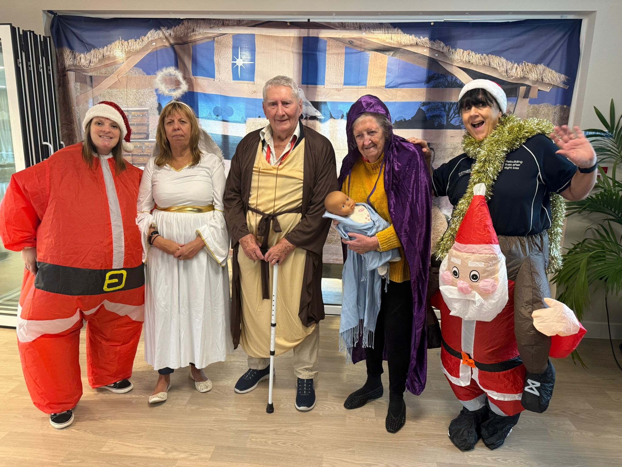 Blind veterans and staff in Christmas fancy dress pose for the camera