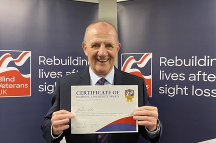 Jules Lee holding his certificate at Founder's Awards 2023