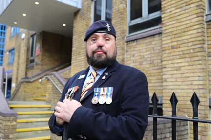 Blind veteran Simon with medals