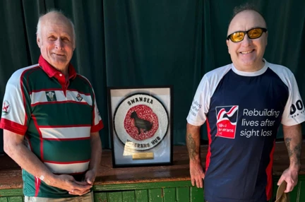 Tony and Dai stood with a Swansea Veterans Hub sign in between them