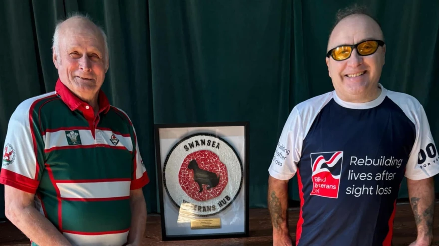 Tony and Dai stood with a Swansea Veterans Hub sign in between them
