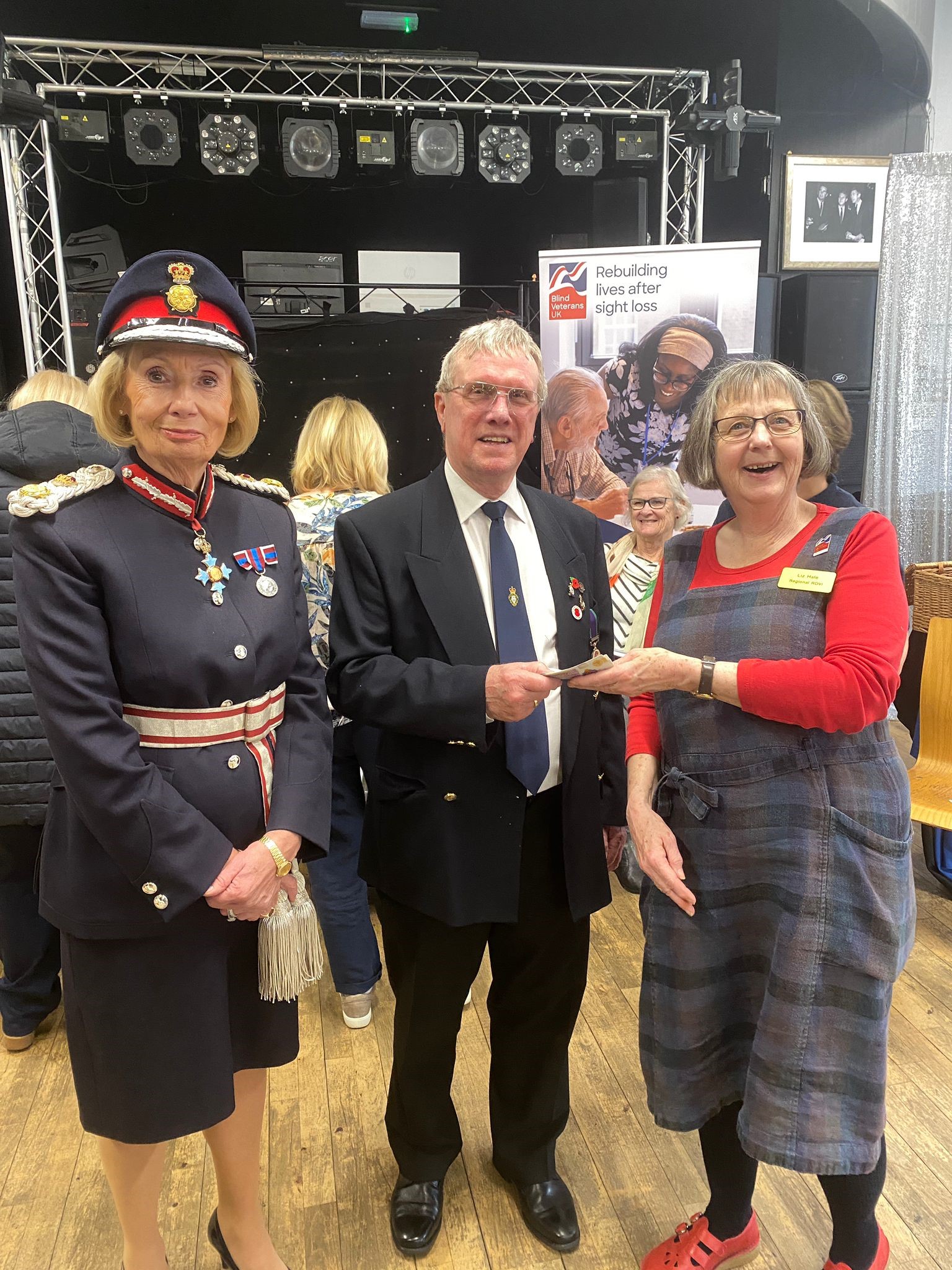 Our Rehab Officer Liz smiles as she accepts the money. The Chairman of Shirebrook Royal British Legion hands over the money. He is standing next to the Lord Lieutenant of Derbyshire.