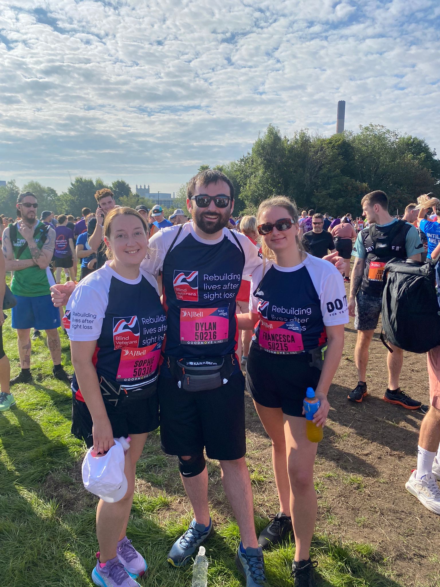Sophie, Dylan and Francesca with their arms around each other, smiling for the camera ahead of the race.