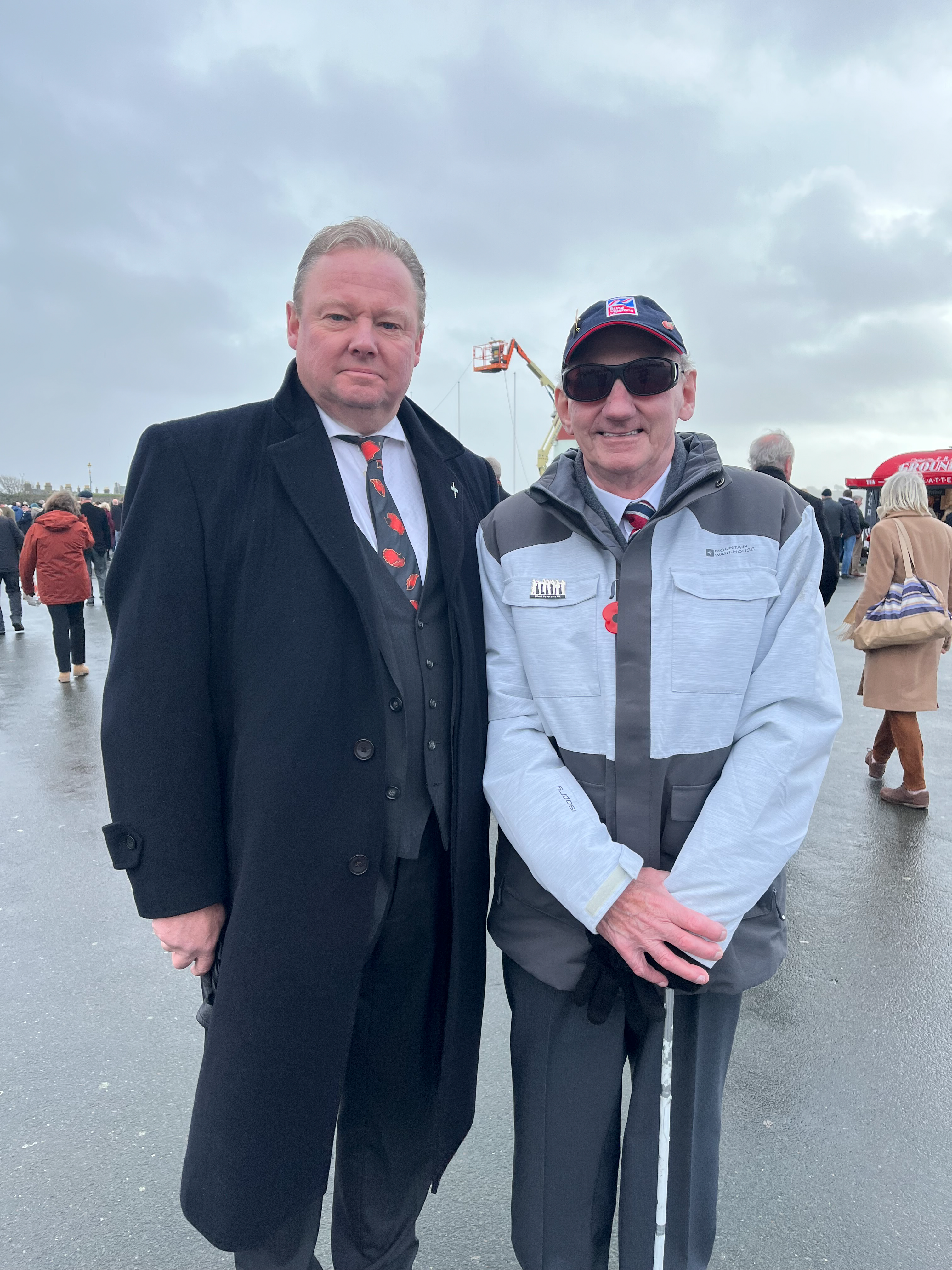 Blind veteran Ted and Blind Veterans UK supporter Fitz at Plymouth Hoe
