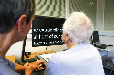 A photo of Janet, Blind veteran, using tech at an Induction week at the Brighton Centre