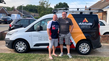 Stu and Sean are stood together in front of Sean's work van
