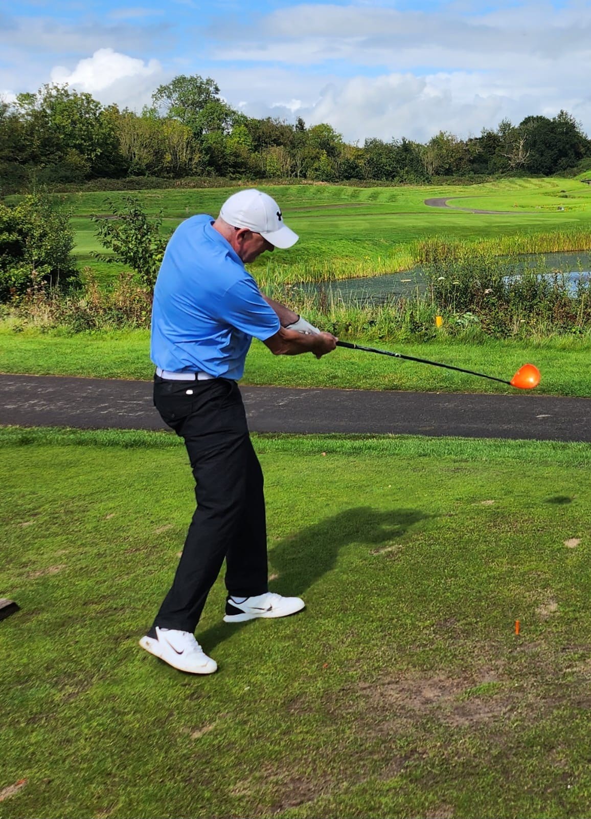 Kevin taking a shot on the golf course