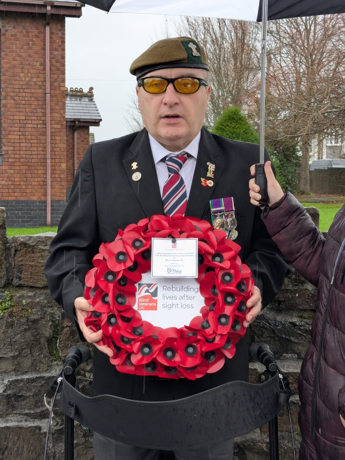 Tony holds his wreath in both hands
