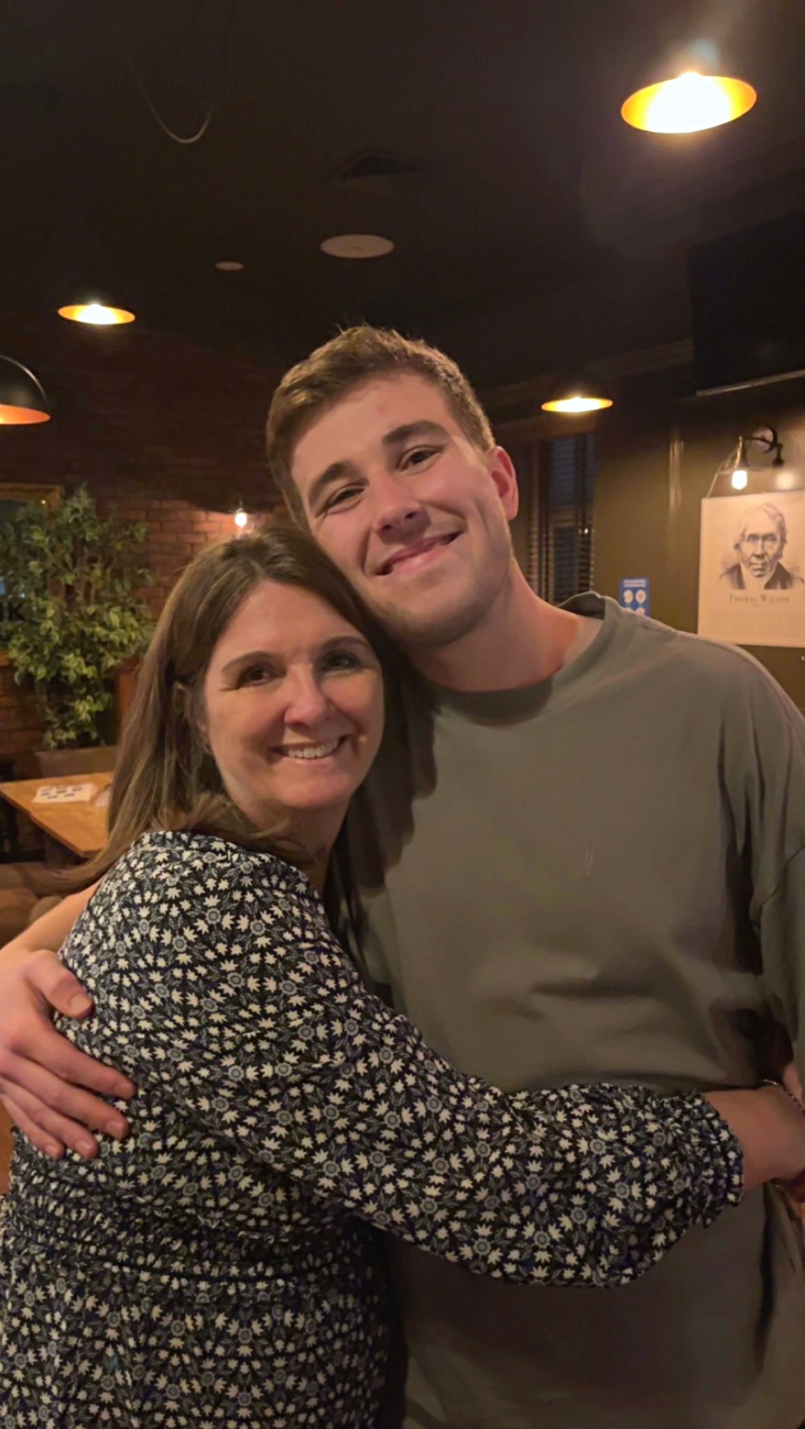 Ryan and Alison smiling with their arms around each other