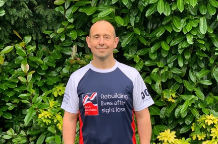 Veteran Justin, in running gear and a Blind Veterans UK top