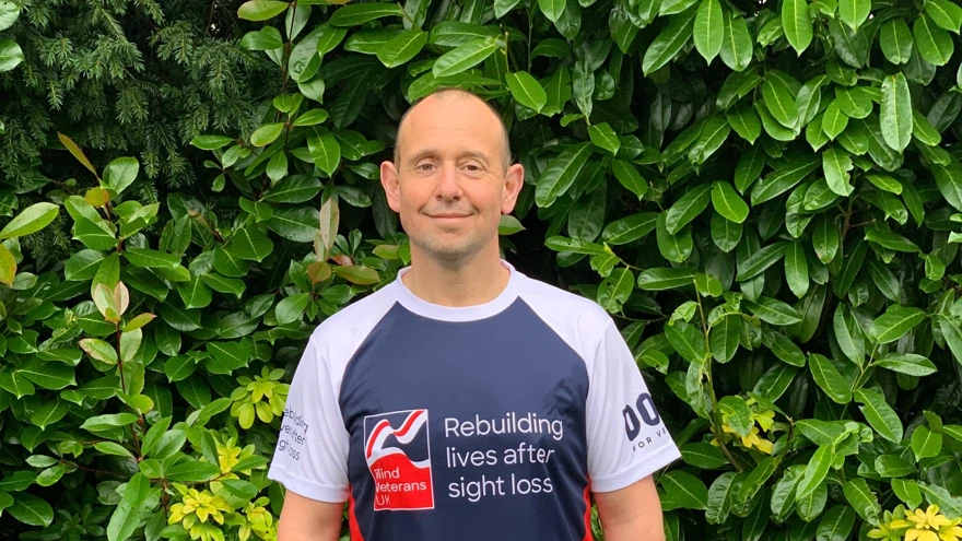 Veteran Justin, in running gear and a Blind Veterans UK top