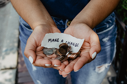 A pair of hands holding money and the words 'make a change'